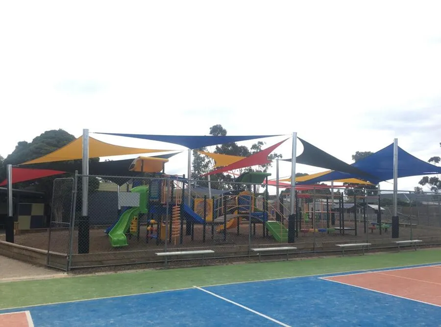 Ten shade sails protecting a playground.webp width=900 height=688